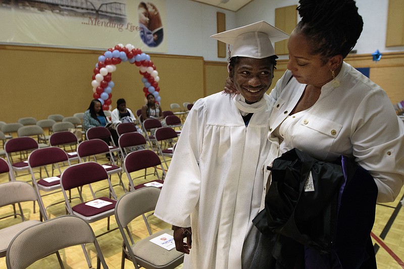 Staff photo by Doug Strickland
Dr. Jacqueline Cothran, right, congratulates Kobeai Ford before Brainerd High School's first-ever summer graduation Tuesday, June 23, 2015, at the North Moore Road Salvation Army, across from the high school, in Chattanooga, Tenn.