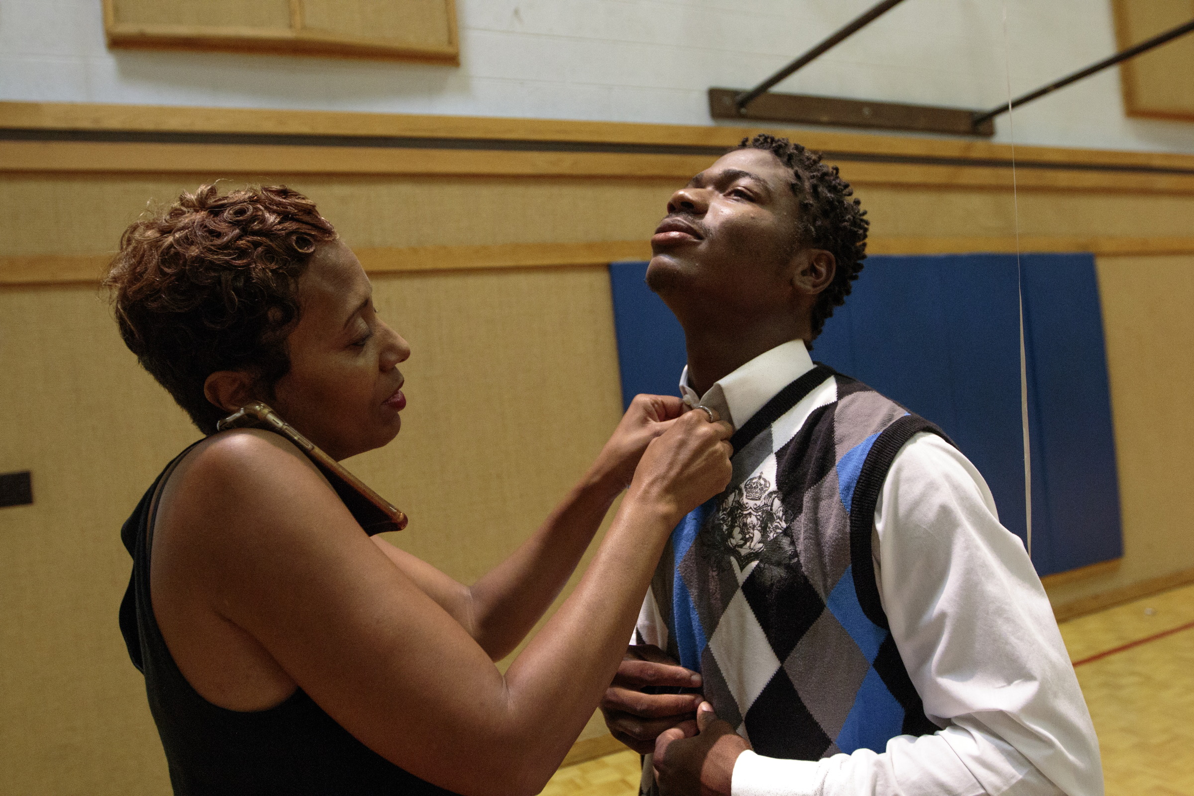 Staff photo by Doug Strickland
Dr. Selina Thedford helps fix Kobeai Ford's collar before Brainerd High School's first-ever summer graduation Tuesday, June 23, 2015, at the North Moore Road Salvation Army, across from the high school, in Chattanooga, Tenn.