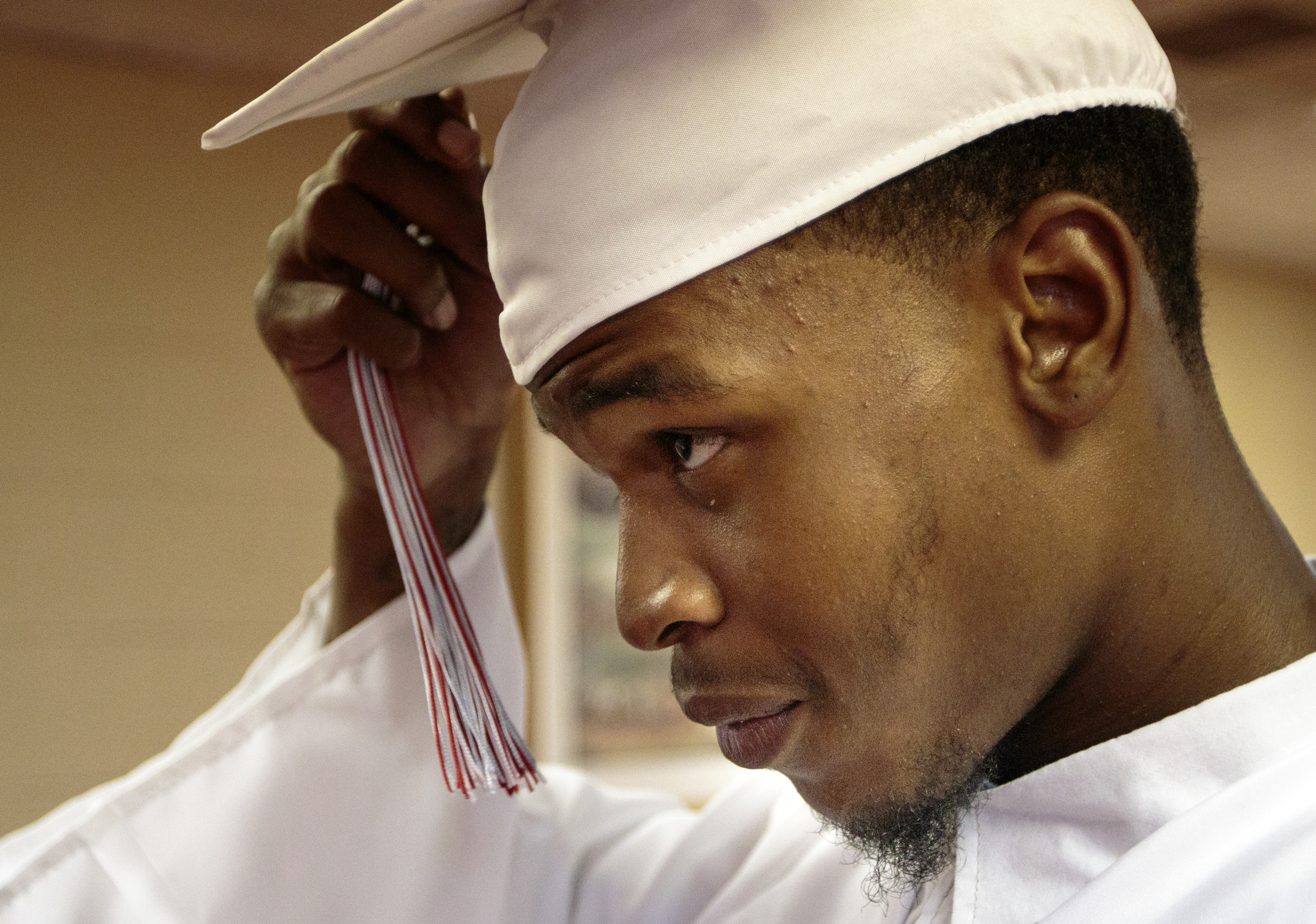 Staff photo by Doug Strickland
Markious Sims straightens his graduation cap and tassel before Brainerd High School's first-ever summer graduation Tuesday, June 23, 2015, at the North Moore Road Salvation Army, across from the high school, in Chattanooga, Tenn.