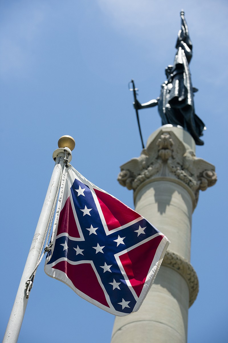 
              A Confederate flag flies next to the Alabama Confederate Memorial on the grounds of the Alabama Capitol building in Montgomery, Ala., Monday, June 22, 2015. (Albert Cesare/The Montgomery Advertiser via AP)  NO SALES; MANDATORY CREDIT
            