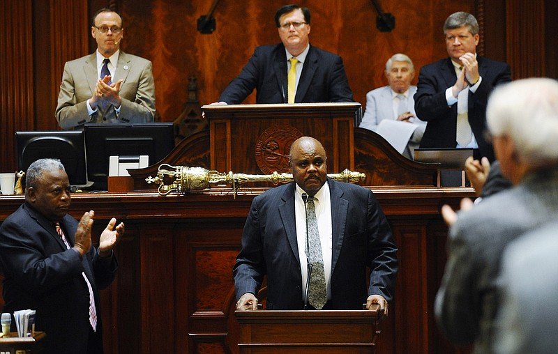 Rep. Joe Neal, D-Richland, receives a standing ovation after speaking during a special session of the state legislature at the South Carolina Statehouse, Tuesday, June 23, 2015, in Columbia, S.C.