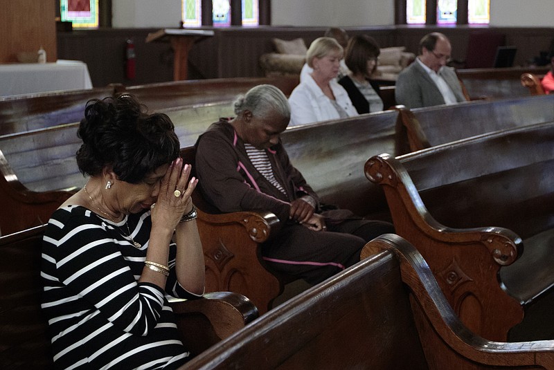 Staff photo by Doug Strickland
Bettye Johnson, left, bows her head with others during a prayer vigil for the Emanuel AME Church on Wednesday, June 24, 2015, at the Wiley United Methodist Church in Chattanooga, Tenn. The vigil was held for victims of last week's shooting at the church in Charleston, South Carolina, which killed 9 people.