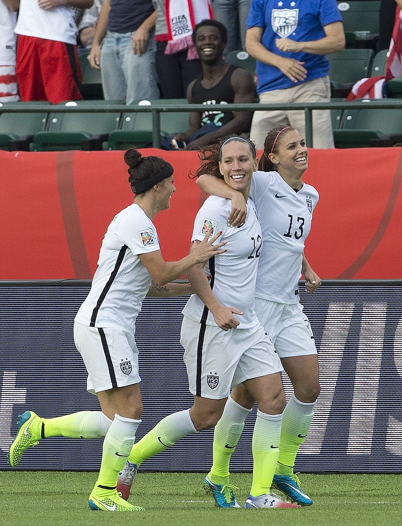 
              United States' Ali Krieger (11), Lauren Holiday (12) and Alex Morgan (13) celebrate a goal against Colombia during second half FIFA Women's World Cup round of 16 soccer action in Edmonton, Alberta, Canada, Monday, June 22, 2015.  (Jason Franson/The Canadian Press via AP) MANDATORY CREDIT
            