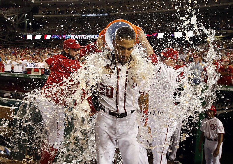 Washington Nationals' Ian Desmond is doused after the team's baseball game against the Atlanta Braves at Nationals Park, Wednesday, June 24, 2015, in Washington. Desmond hit a sacrifice fly to score the winning run. The Nationals won 2-1 in 11 innings. 