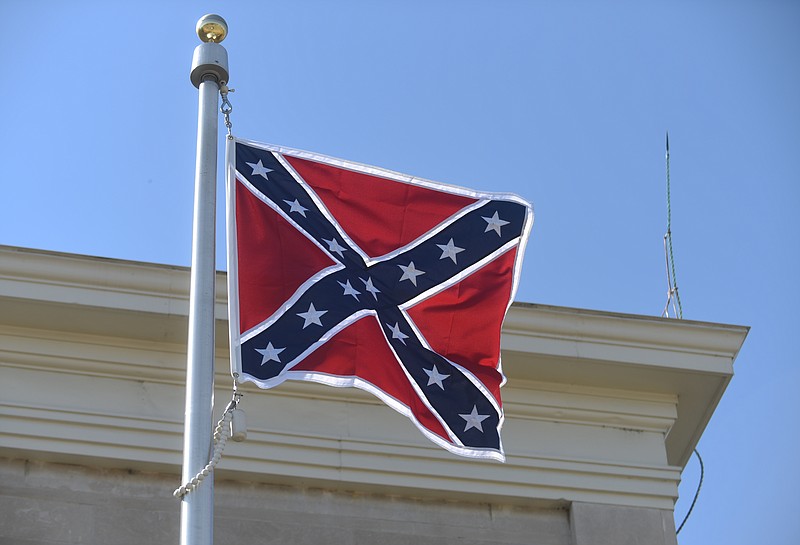 A Confederate flag flies above the Chattooga County Courthouse Wednesday in Summerville, Ga.