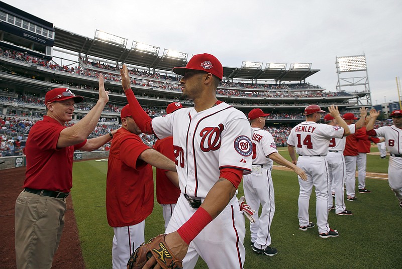 Washington Nationals shortstop Ian Desmond (20) celebrates with his teammates after a baseball game against the Atlanta Braves at Nationals Park, Thursday, June 25, 2015, in Washington. The Nationals won 7-0. (AP Photo/Alex Brandon)