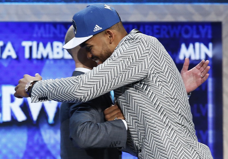 Karl-Anthony Towns, right, is greeted by NBA Commissioner Adam Silver after the Minnesota Timberwolves selected Towns, a Kentucky center, with the top pick in the NBA basketball draft on Thursday, June 25, 2015, in New York.