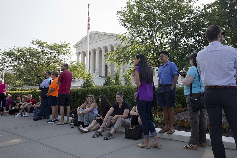 People wait in line to enter the Supreme Court in Washington on Thursday June 25, 2015.