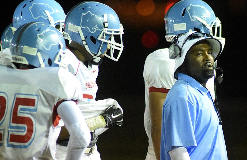 Brainerd head coach Brian Gwyn checks the scoreboard as his Panther's jump out to an early lead over Howard.