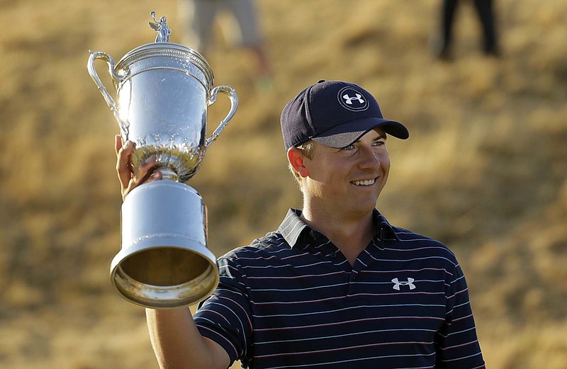 Jordan Spieth holds up the trophy after winning the U.S. Open golf tournament at Chambers Bay on Sunday, June 21, 2015 in University Place, Wash. (AP Photo/Ted S. Warren)