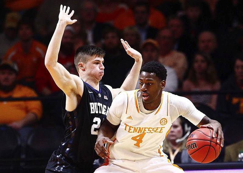 Tennessee forward Armani Moore (4) works against Butler guard Kellen Dunham (24) in the first half of an NCAA college basketball game on Sunday, Dec. 14, 2014, in Knoxville, Tenn. (AP Photo/Wade Payne)