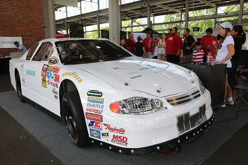 Attendees of the 2014 Man Xpo await their turn to get in the NASCAR simulator.