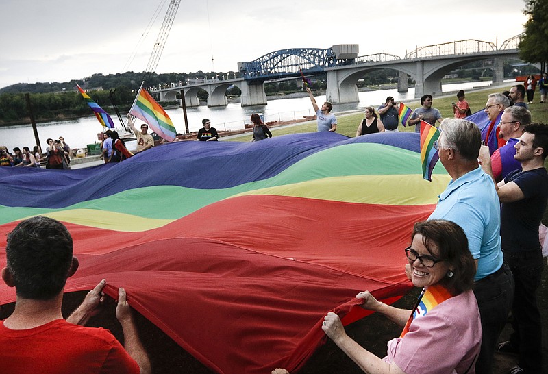 Staff photo by Doug Strickland
A 100-foot rainbow flag is unfurled during a celebration of the U.S. Supreme Court's ruling in favor of same-sex marriage held Friday, June 26, 2015, at Ross's Landing in Chattanooga, Tenn. Supporters gathered to praise past and current activists in their work towards marriage equality.