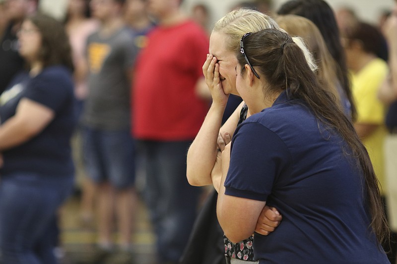Photo by Dan Henry / The Chattanooga Times Free Press. Mollie Childs, left, and Jessica Bice become emotional during a candlelight vigil on Friday June 26, 2015 for Ocoee Middle School's band director, Brian Gallaher, who was one of the six people killed in a crash on I-75 late Thursday evening. 