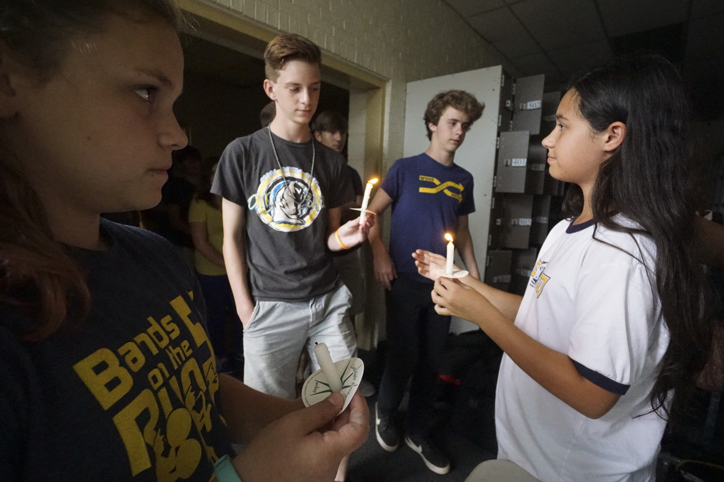 Photo by Dan Henry / The Chattanooga Times Free Press. Arianna Heil, left, and Taylor Guyton, right, hand out candles during a vigil on Friday June 26, 2015 for Ocoee Middle School's band director, Brian Gallaher, who was one of the six people killed in a crash on I-75 late Thursday evening.