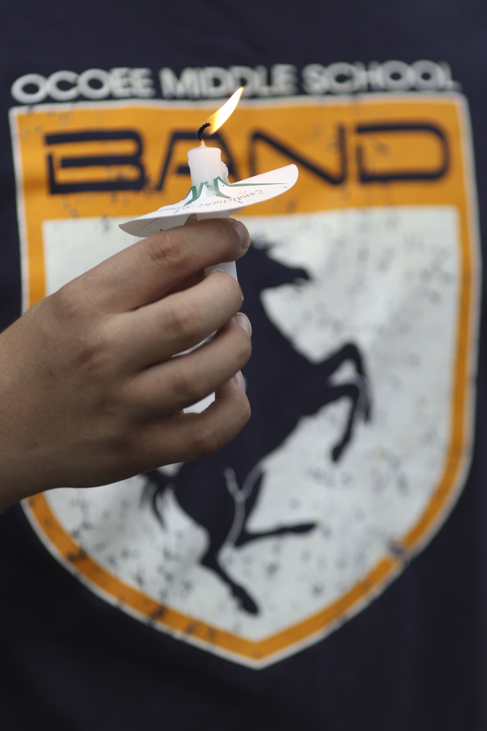 Photo by Dan Henry / The Chattanooga Times Free Press. Evan Gateley holds a candle during a vigil on Friday June 26, 2015 for Ocoee Middle School's band director, Brian Gallaher, who was one of the six people killed in a crash on I-75 late Thursday evening.