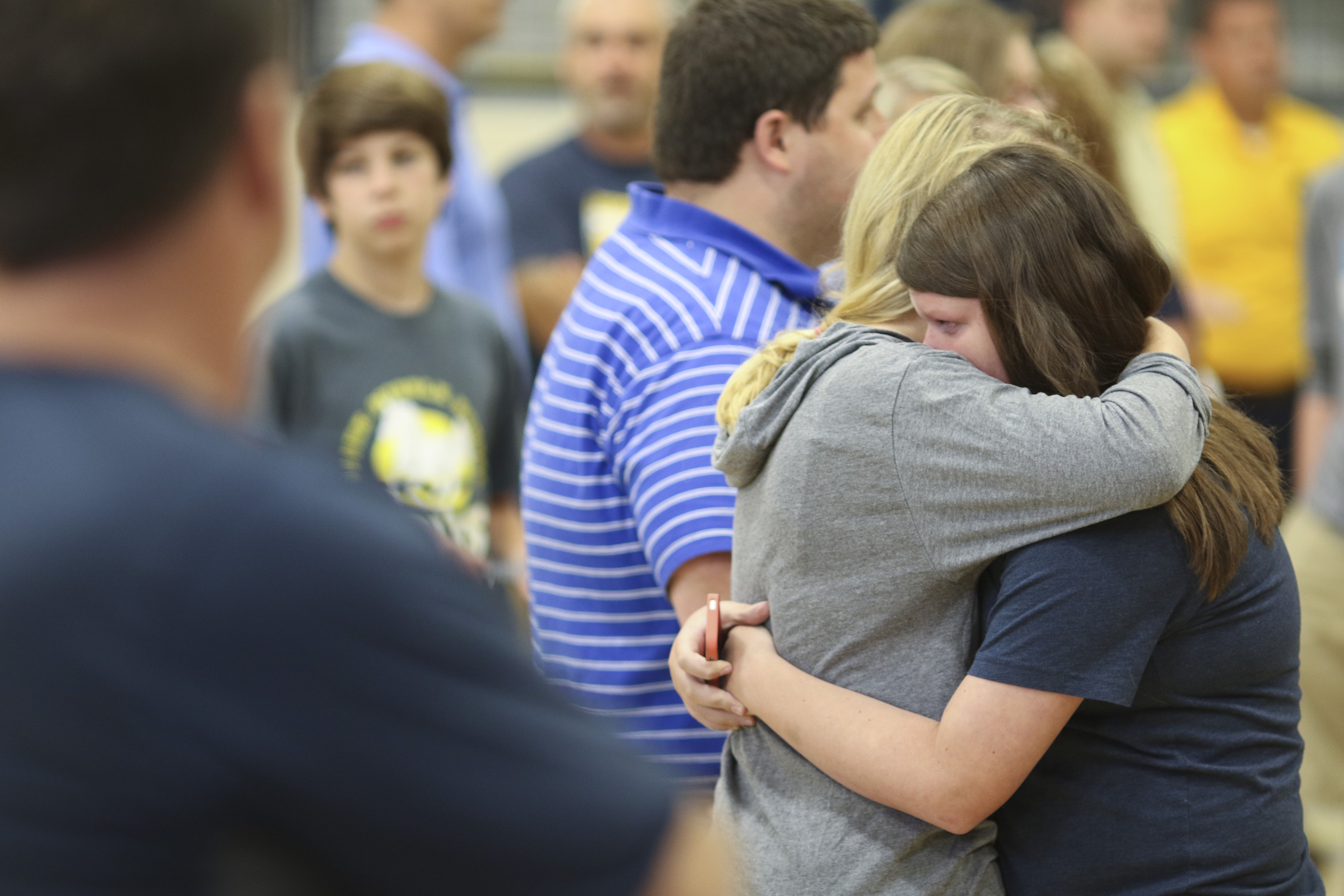 Photo by Dan Henry / The Chattanooga Times Free Press. Mallory Wickam, left, and Lizzie Goggins embrace during a candlelight vigil on Friday June 26, 2015 for Ocoee Middle School's band director, Brian Gallaher, who was one of the six people killed in a crash on I-75 late Thursday evening.