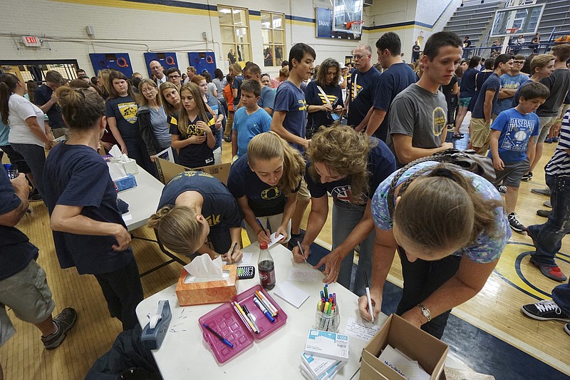 Photo by Dan Henry / The Chattanooga Times Free Press. Students, friends and family fill out memory cards during a candlelight vigil on Friday June 26, 2015 for Ocoee Middle School's band director, Brian Gallaher, who was one of the six people killed in a crash on I-75 late Thursday evening. 
