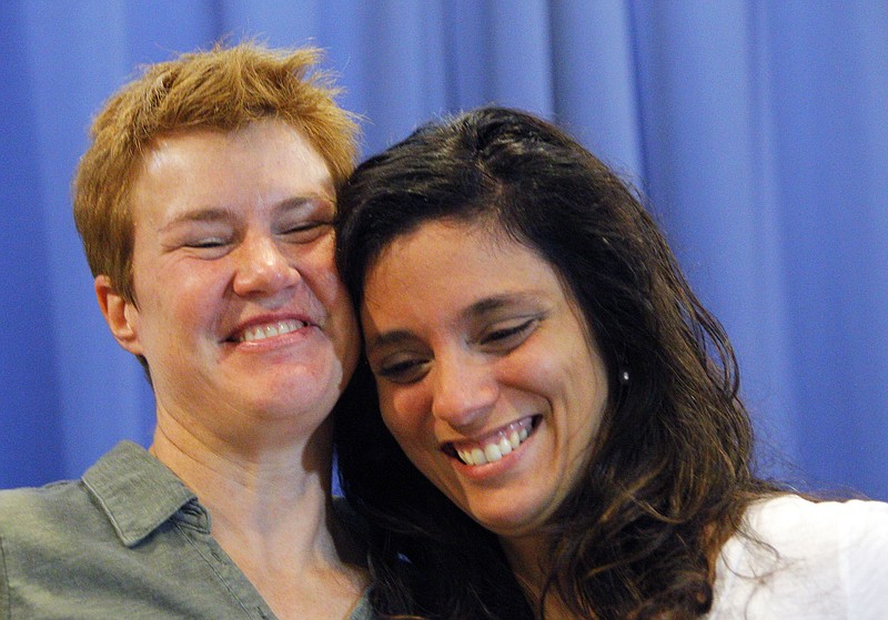 
              Val Tanco, right, and Sophie Jesty, plaintiffs in the Supreme Court case on gay marriage, smile during a news conference in Knoxville, Tenn. on Friday, June 26, 2015. Friday's Supreme Court ruling legalizes gay marriage nationwide, including in the 14 remaining states with bans. They moved to Tennessee for work after marrying in New York. (AP Photo/Wade Payne)
            