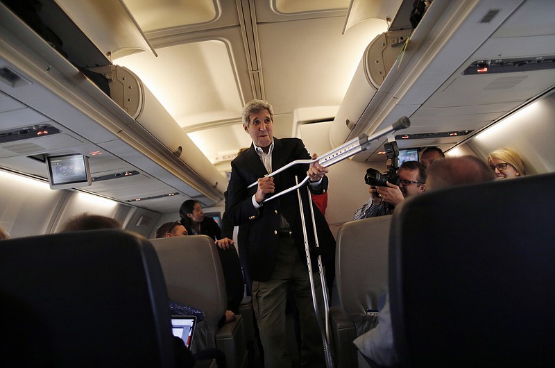 
              Secretary of State John Kerry plays with his crutches as he talks to reporters before leaving from Andrews Air Force Base, Md., Friday, June 26, 2015, en route to Vienna, Austria. Kerry flies to Vienna on Friday to join negotiators from six powers and Iran seeking an agreement under which Tehran would curb its nuclear program in exchange for relief from economic sanctions that have crippled its economy.   (Carlos Barria/Pool Photo via AP)
            