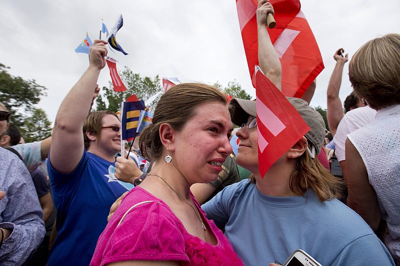 Ariel Olah of Detroit, left, and her fiancee Katie Boatman, are overcome by emotion outside the Supreme Court in Washington, Friday, June 26, 2015, as the ruling on same-sex marriage was announced. The court declared that same-sex couples have a right to marry anywhere in the US.