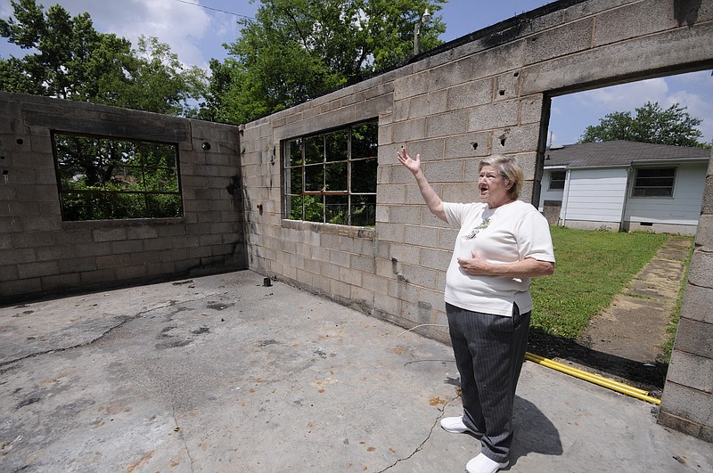 Staff photo by Tim Barber
Terry Lee Melton, 73, stands inside her garage that recently burned behind her house in East Lake. "There was a garage apartment above, and I let some homeless people live there until they got on their feet," Melton said on Thursday, June 25, 2015.
