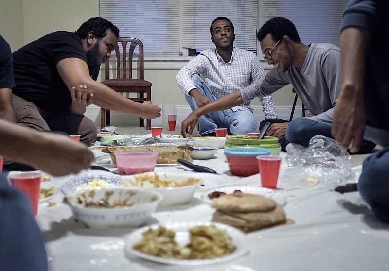 Staff photo by Doug Strickland
Mohamed Khalafalla, Haytham Saeed, and Elamin Mohamed, from left, friends of deceased UTC student Ali Ali, gather to break their Ramadan fast together Wednesday, June 24, 2015, in an apartment in Chattanooga, Tenn. The community of Sudanese students and faculty at UTC are very close-knit, and they say they knew something was wrong when Ali did not come home for dinner the night he went missing.