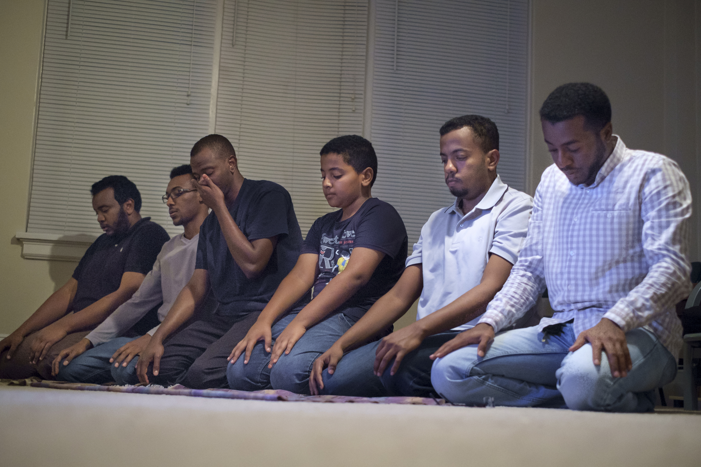 Staff photo by Doug Strickland
Friends of deceased UTC student Ali Ali pray after breaking their Ramadan fast together Wednesday, June 24, 2015, in an apartment in Chattanooga, Tenn. The community of Sudanese students and faculty at UTC are very close-knit, and they say they knew something was wrong when Ali did not come home for dinner the night he went missing.