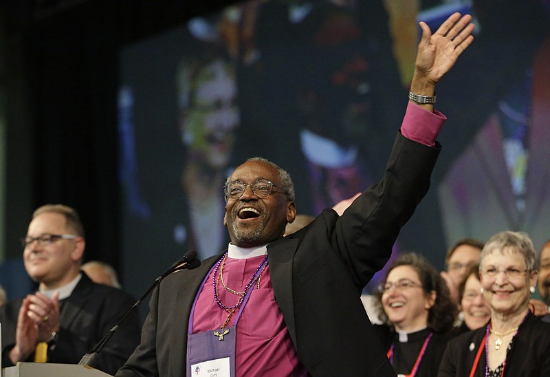 Bishop Michael Curry, of North Carolina, waves to the crowd after being elected the Episcopal Church's first African-American presiding bishop at the Episcopal General Convention Saturday, June 27, 2015, in Salt Lake City. Curry won the vote in a landslide. 
