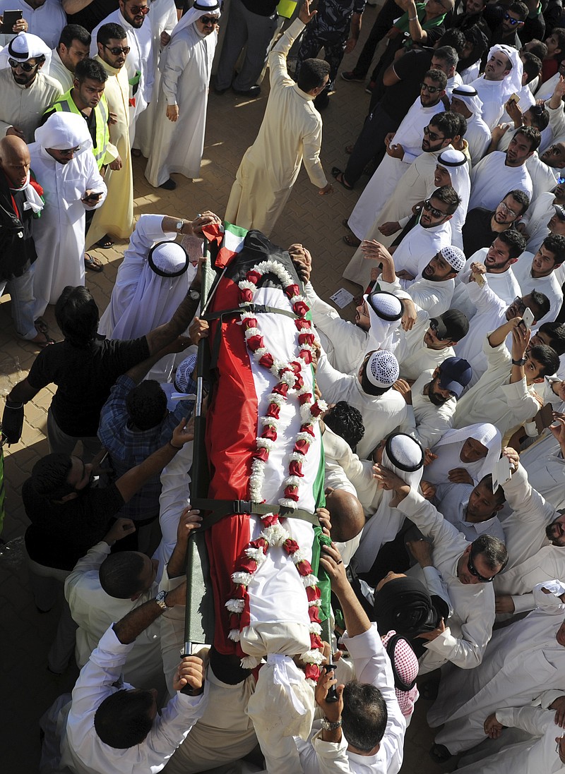 
              Thousands of Sunnis and Shiites from across the country take part in a mass funeral procession for 27 people killed in a suicide bombing that targeted the Shiite Imam Sadiq Mosque a day earlier, at Kuwait's Grand Mosque in Kuwait city, Kuwait, Saturday, June 27, 2015. Police in Kuwait said they are interrogating a number of suspects with possible links to the suicide bombing, which was claimed by an affiliate of the Islamic State group. (AP Photo)
            