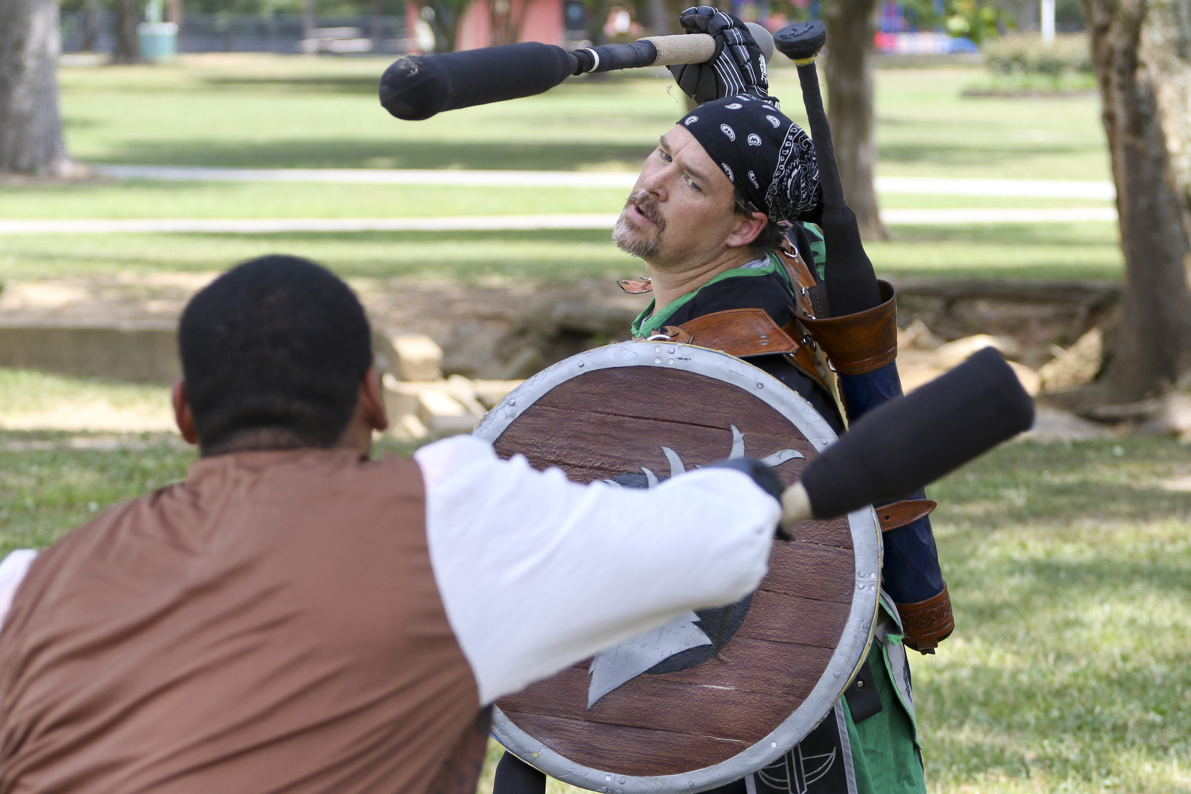 Staff Photo by Dan Henry. Felipe Argueta "Captain Cuddles" left, and Jason Parker "Deryk MacCoill", right, battle during an Amtgard practice at Heritage Park in East Brainerd, Tenn., on Wednesday, June 24, 2015. Amtgard is an international organization where players use padded weapons to battle each other in medieval and fantasy based game scenarios.