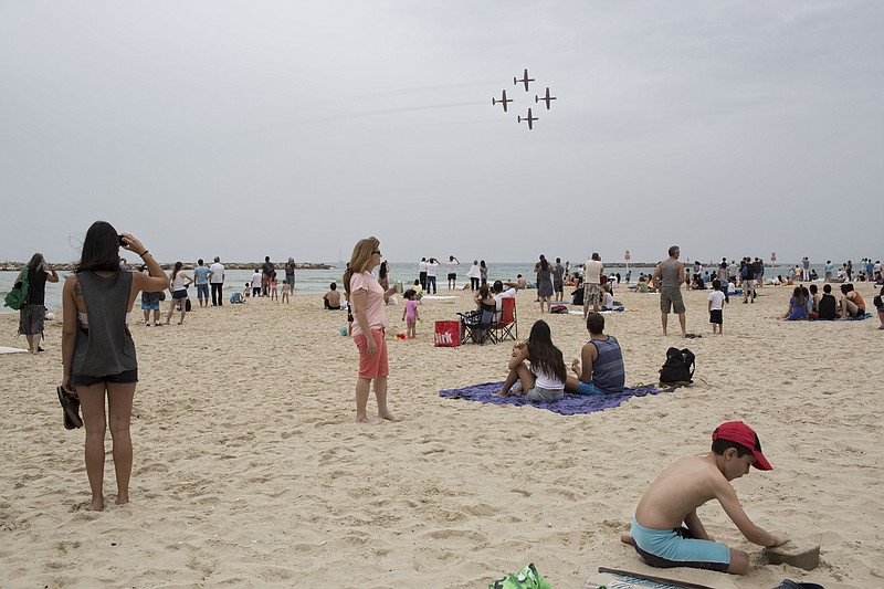 
              FILE - In this Tuesday, May 6, 2014 file photo, Israelis watch an air show during Independence Day in Tel Aviv. The world's Jewish population has grown to be nearly as large as it was before the Holocaust, an Israeli think tank said in its annual report Sunday, June 28, 2015. (AP Photo/Oded Balilty, File)
            