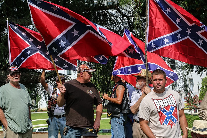 Attendees of a pro-Confederate flag rally hold flags and listen to speakers at the Alabama state capitol building on Saturday, June 27, 2015, in Montgomery, Ala.