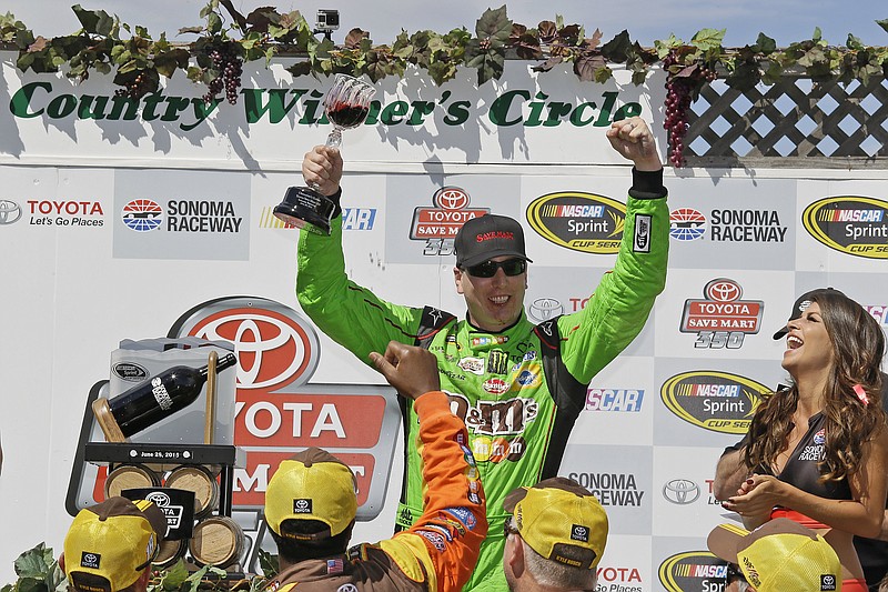 Kyle Busch celebrates after winning the NASCAR Sprint Cup Series auto race Sunday, June 28, 2015, in Sonoma, Calif.
