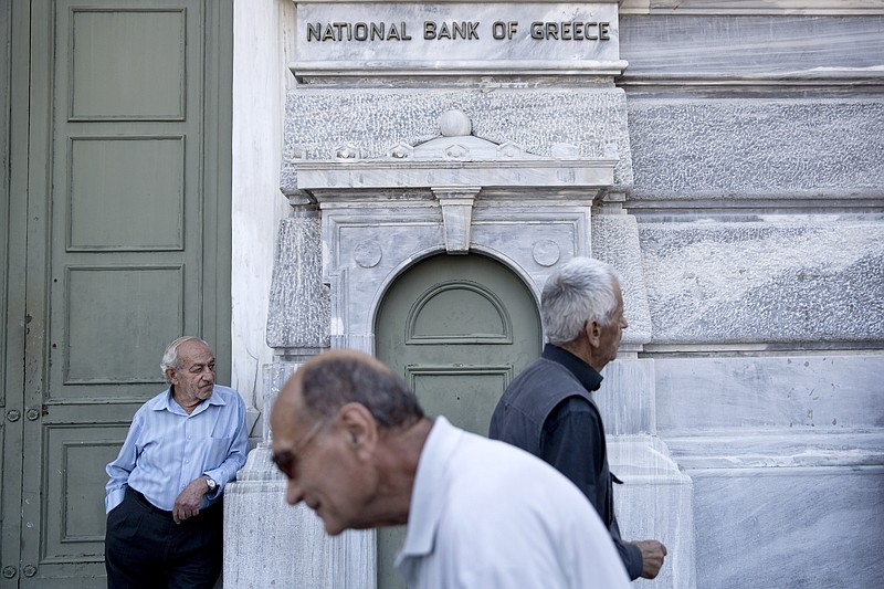 
              Elderly people wait to receive their pension outside the National bank of Greece headquarters in Athens, Monday, June 29, 2015. Anxious Greek pensioners swarmed bank branches hoping to be able to receive their pensions Monday and others lined up at ATMs as they gradually began dispensing cash again on the first day of capital controls imposed in a dramatic twist in Greece’s five-year financial saga. (AP Photo/Petros Giannakouris)
            