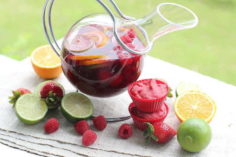 Peach and raspberry sangria with "ice" cubes made from a strawberry puree. (AP Photo/Matthew Mead)