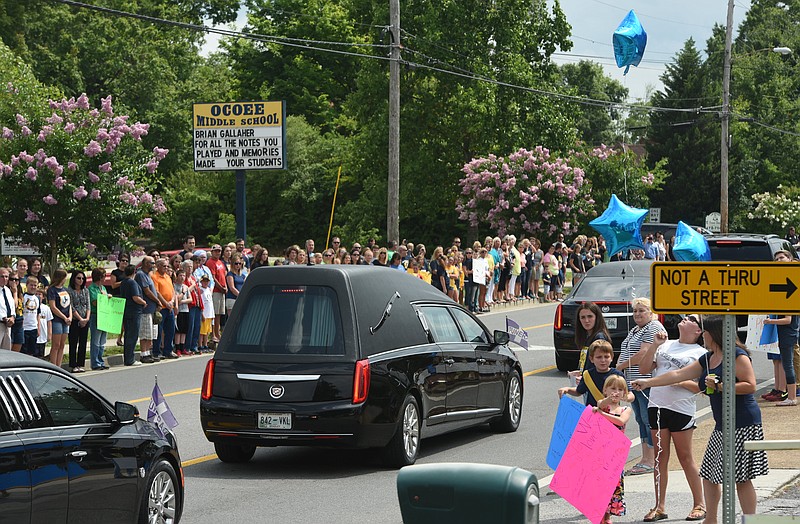 Staff photo by Tim Barber
Dozens of Cleveland residents and students  line the street in front of Ocoee Middle School as the funeral procession for band leader Brian Gallaher passes Monday afternoon in Cleveland, Tenn., June 29, 2015.
