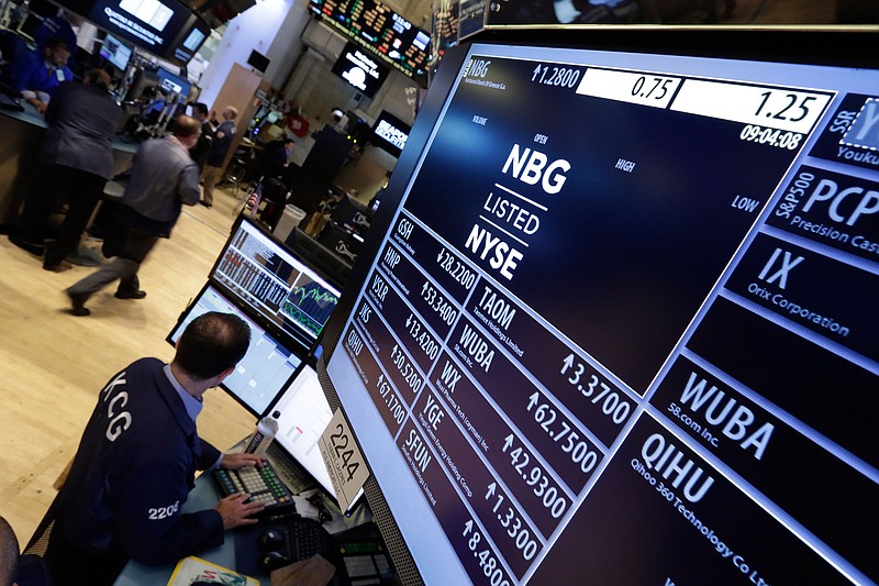 
              A specialist works at the post that trades National Bank of Greece, on the floor of the New York Stock Exchange, Monday, June 29, 2015. Anxious Greek pensioners swarmed closed bank branches Monday in the hope of getting their pensions, while queues formed at ATMs as they gradually began dispensing cash again following the imposition of strict controls on capital. (AP Photo/Richard Drew)
            