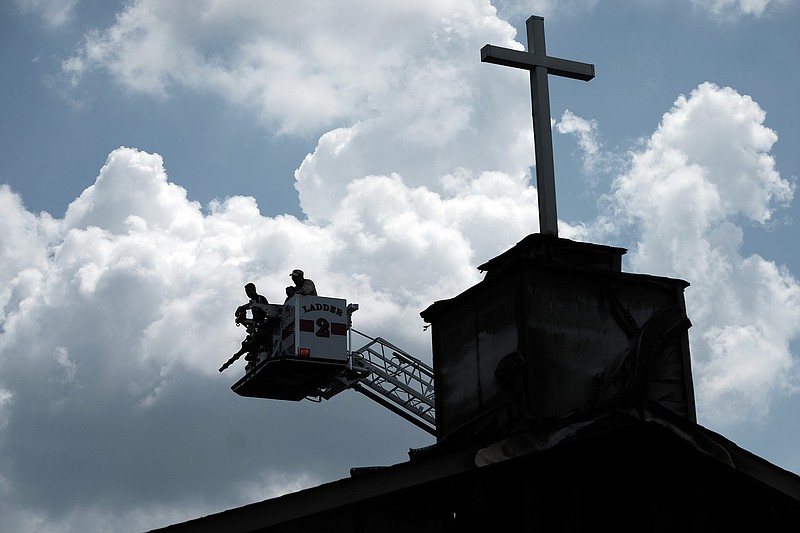 Investigators use a ladder truck to get a bird's eye view as they try to determine the cause of a fire that destroyed the Glover Grove Baptist Church in Warrenville, S.C.