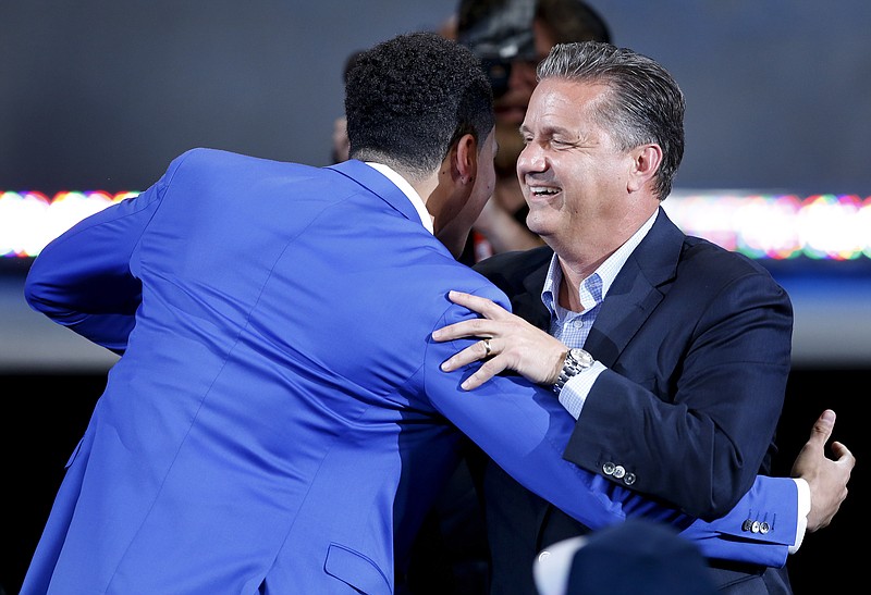 Kentucky coach John Calipari congratulates Devin Booker after Booker was elected 13th overall by the Phoenix Suns during the NBA basketball draft Thursday, June 25, 2015, in New York. 