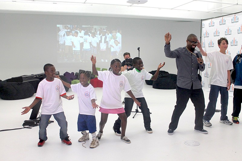 Students watched Cupid to learn the "Cupid Shuffle" before dancing with him.