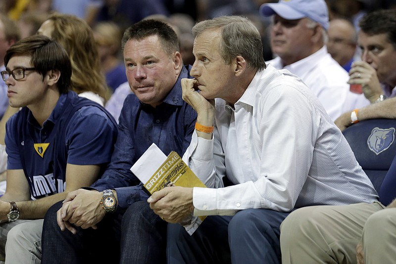 In this May, 2015, file photo, Tennessee head football coach Butch Jones, center, and head basketball coach Rick Barnes, right, watch the first half of Game 4 of a second-round NBA basketball Western Conference playoff series between the Memphis Grizzlies and the Golden State Warriors in Memphis.