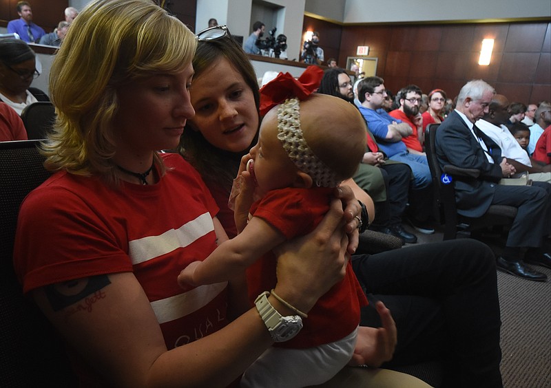 Newlyweds Val Hill, 25, left, and Megan Turner, 24, hold their 3-month-old little girl, Ellie Hill, during the Chattanooga City Council meeting Tuesday evening. Next week, the council will take up a nondiscrimination ordinance after portions of the ordinance had to be rewritten.