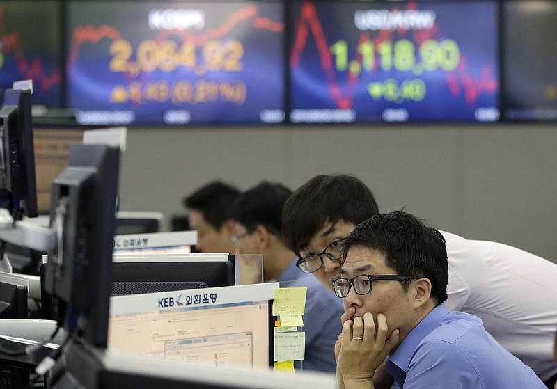 
              Currency traders watch monitors at the foreign exchange dealing room of the Korea Exchange Bank headquarters in Seoul, South Korea, Tuesday, June 30, 2015. Asian stock markets bounced back Tuesday, recouping some of the previous day's sharp losses, but investors remained worried the crisis in Greece could spread to other financially weak countries. (AP Photo/Ahn Young-joon)
            