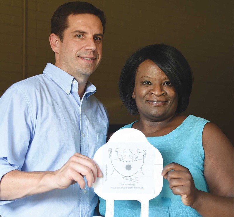 Staff photo by Angela Lewis FosterTony Iwancyk, left, and Felicia Jackson hold a prototype for CPR Lifewrap in the Launch office.