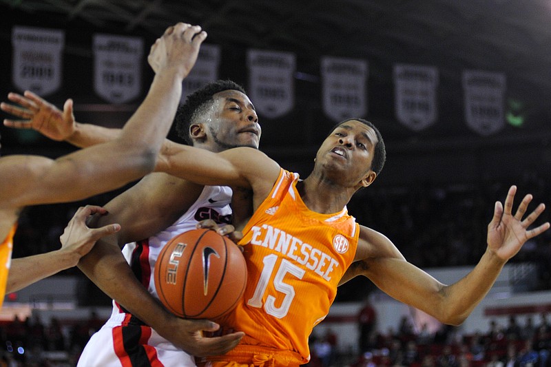 Georgia forward/center Yante Maten, left, and Tennessee guard Detrick Mostella (15) compete for a rebound during an NCAA college basketball game, Saturday, Feb. 7, 2015, in Athens, Ga. (AP Photo/Athens Banner-Herald, AJ Reynolds) MAGS OUT; MANDATORY CREDIT , TV OUT