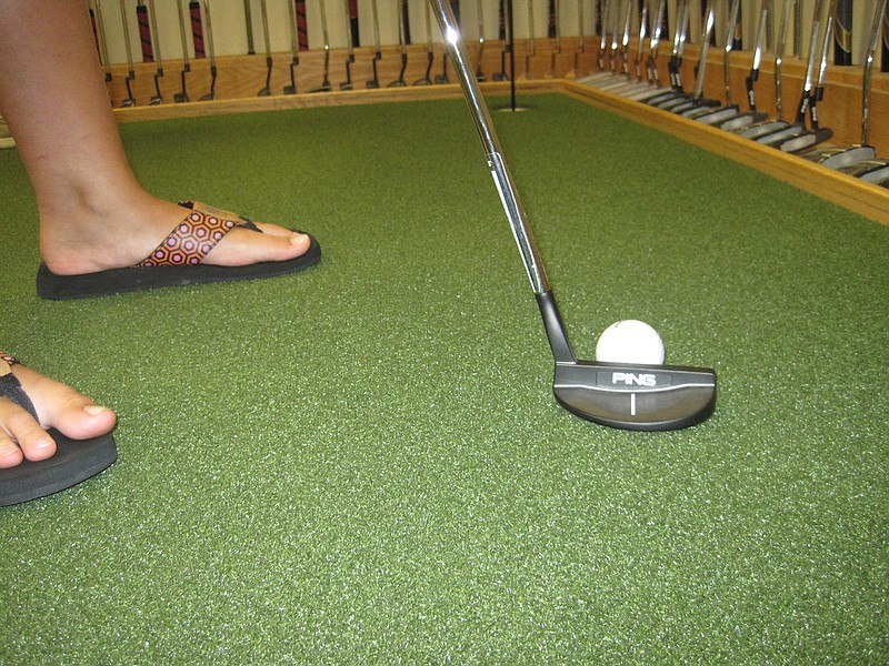 Staff Photos by David Uchiyama
Or for the girl in flip-flops...
Hayden Matthews tested a few different putters at Golf Headquarters on Tuesday. Finding the perfect putter is more about feel than and results than statistics and laser-tracking