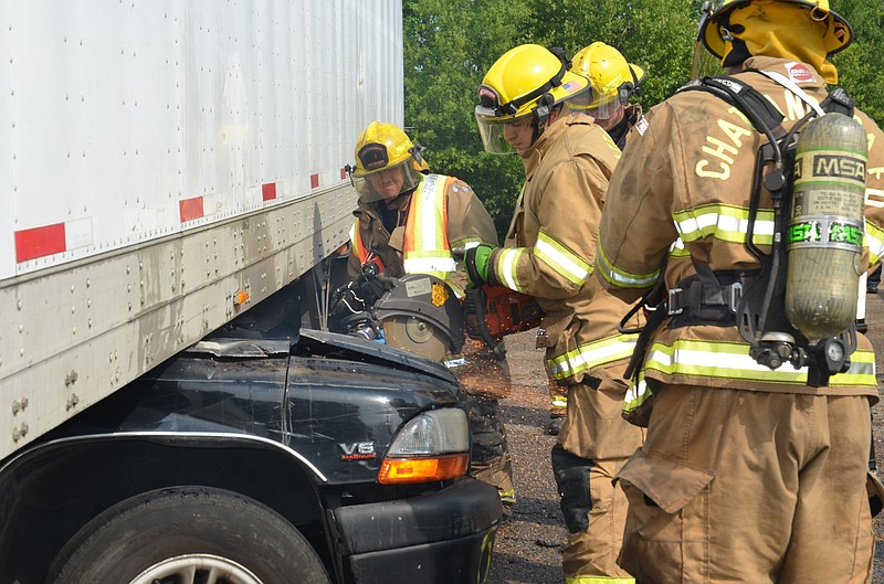 Chattanooga Fire Department Photo by Bruce Garner
Emergency personal work to remove a accident victim from a wreck on Amnicola Highway.