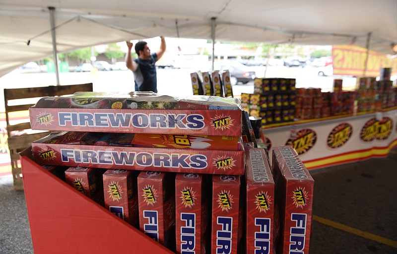 Staff photo by John Rawlston/Chattanooga Times Free Press 
David Aguilar rolls up the sides of a TNT Fireworks tent in the parking lot of a shopping center on North Glenwood in Dalton, Ga., on Tuesday, June 30,  2015. New state laws regulating fireworks take effect July 1, 2015, increasing the taxes of firework sales and allowing for the sale of larger fireworks. Larger fireworks must be sold in a permanent building and not in tents, and TNT is opening a store for that purpose in the shopping center.  