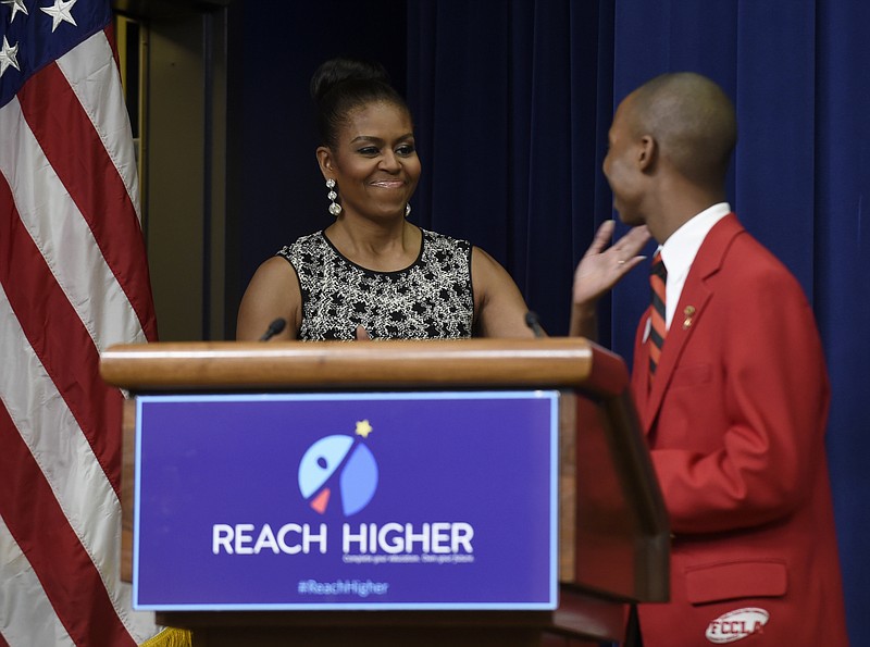 
              First lady Michelle Obama reaches out to give Jacob Smith, of Whitehouse, Texas, a hug before speaking at the Celebrating Innovations in Career and Technical Education (CTE) event in the South Court Auditorium in the White House complex in Washington, Tuesday, June 30, 2015. Obama recognized students and educators for their work connecting the classroom to real-life career opportunities. (AP Photo/Susan Walsh)
            